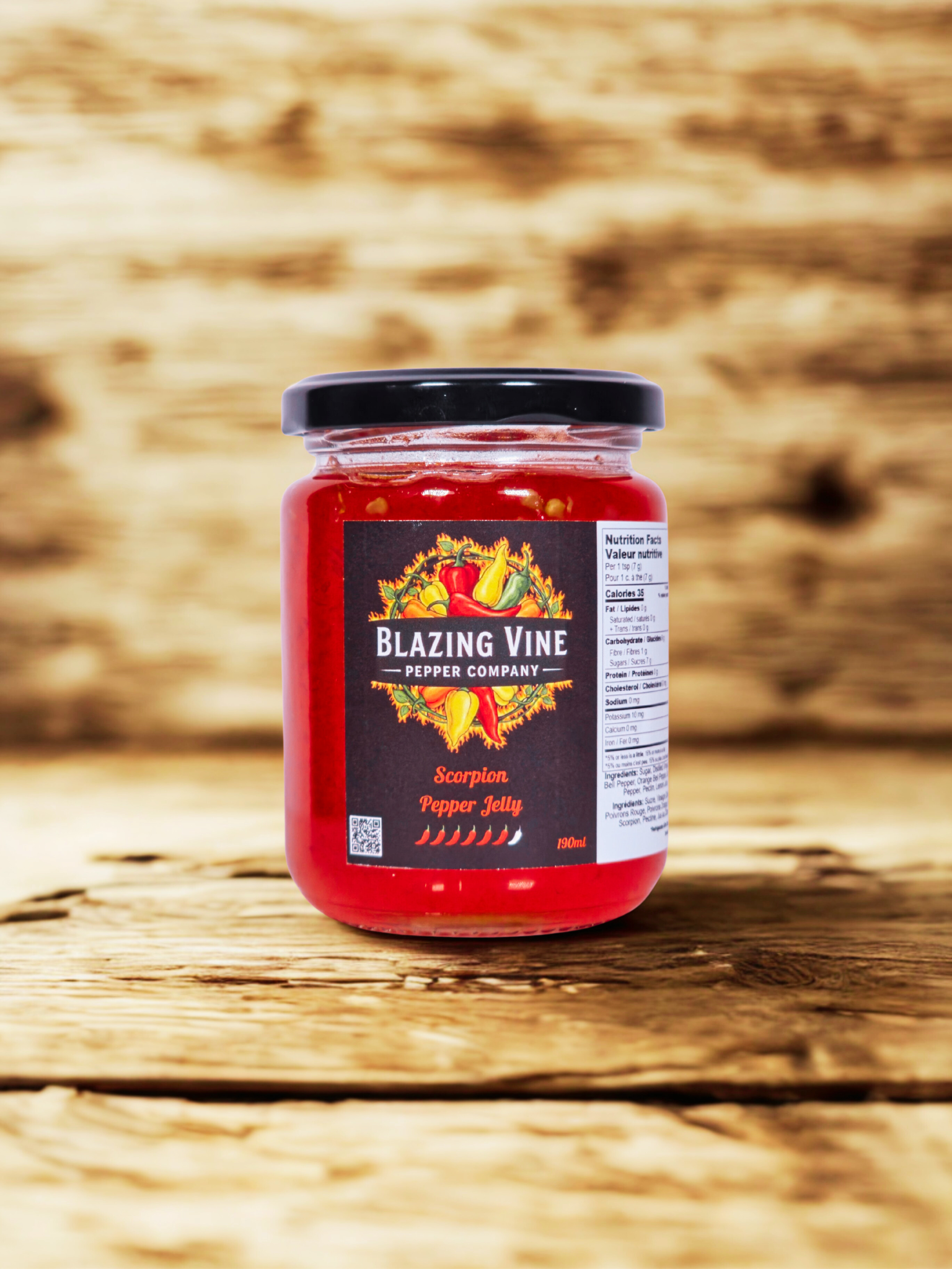 Blazing Vine Scorpion Pepper Jelly — deep red jelly in a glass jar on rustic wood